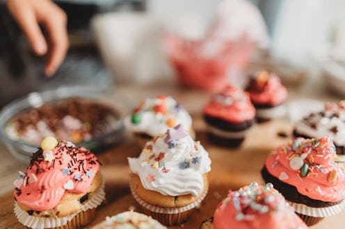 Young woman preparing cupcakes in the kitchen