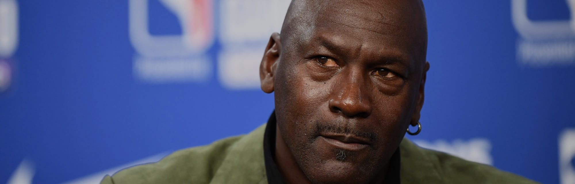 Former NBA star and owner of Charlotte Hornets team Michael Jordan looks on as he addresses a press ...