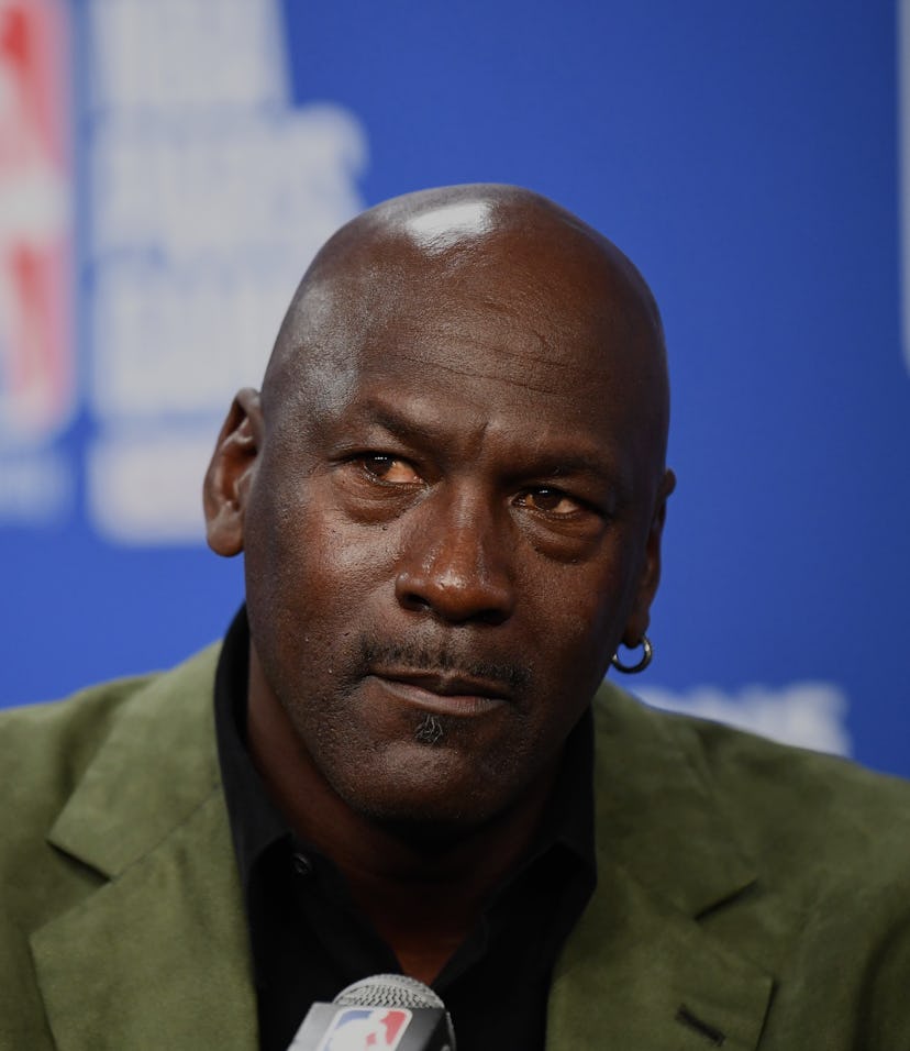 Former NBA star and owner of Charlotte Hornets team Michael Jordan looks on as he addresses a press ...