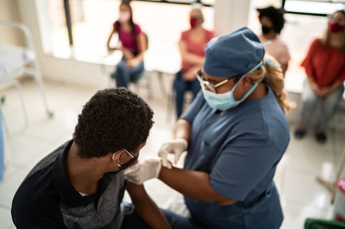 Teenager boy being vaccinated