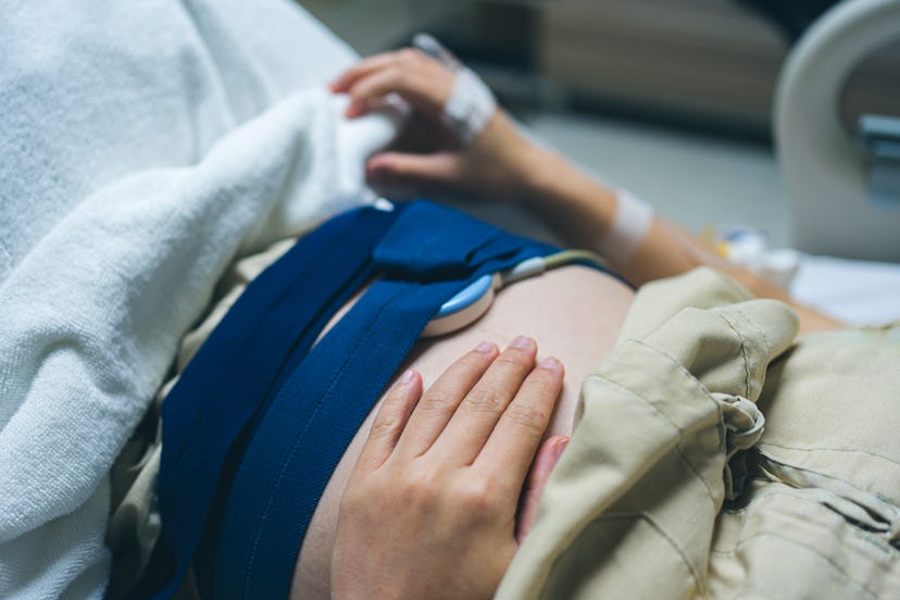 a woman in labor, belly with monitors