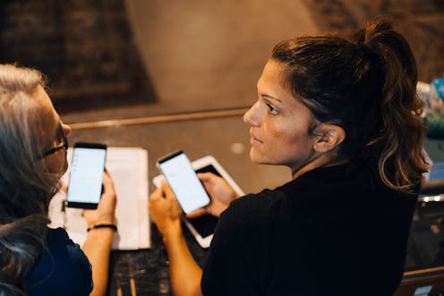 women looking at their phones