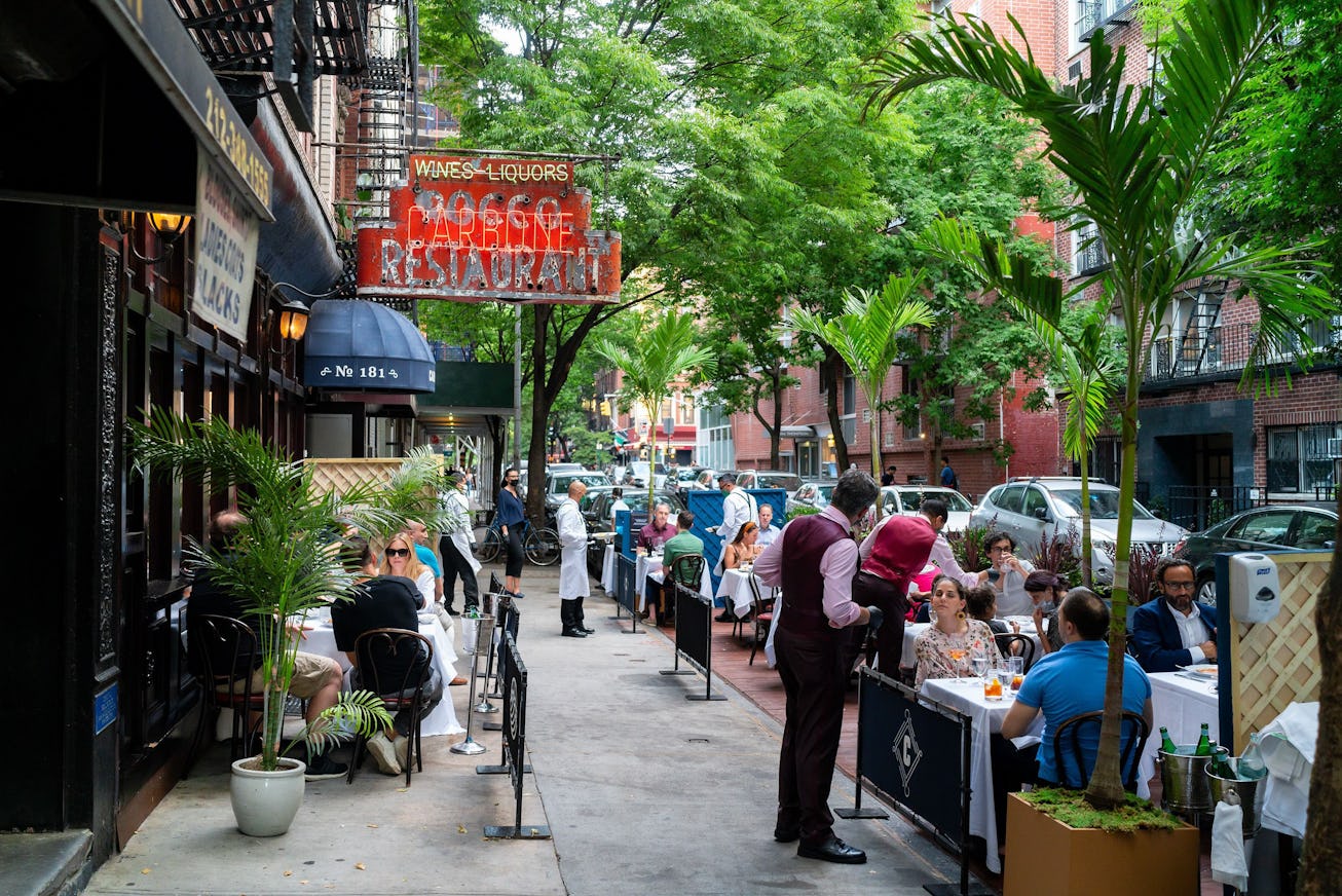 NEW YORK, NEW YORK - JUNE 25: Customers at Carbone are served at outside tables as the city moves in...