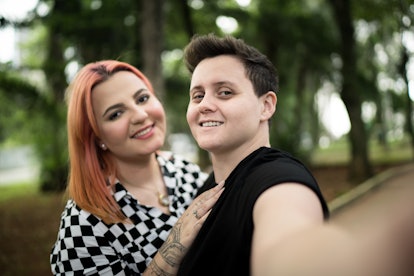 Lesbian couple taking a selfie at park