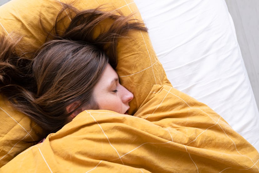 A woman sleeping in bed.