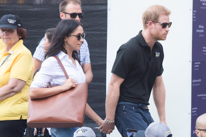 Meghan Markle and Prince Harry holding hands in 2017.