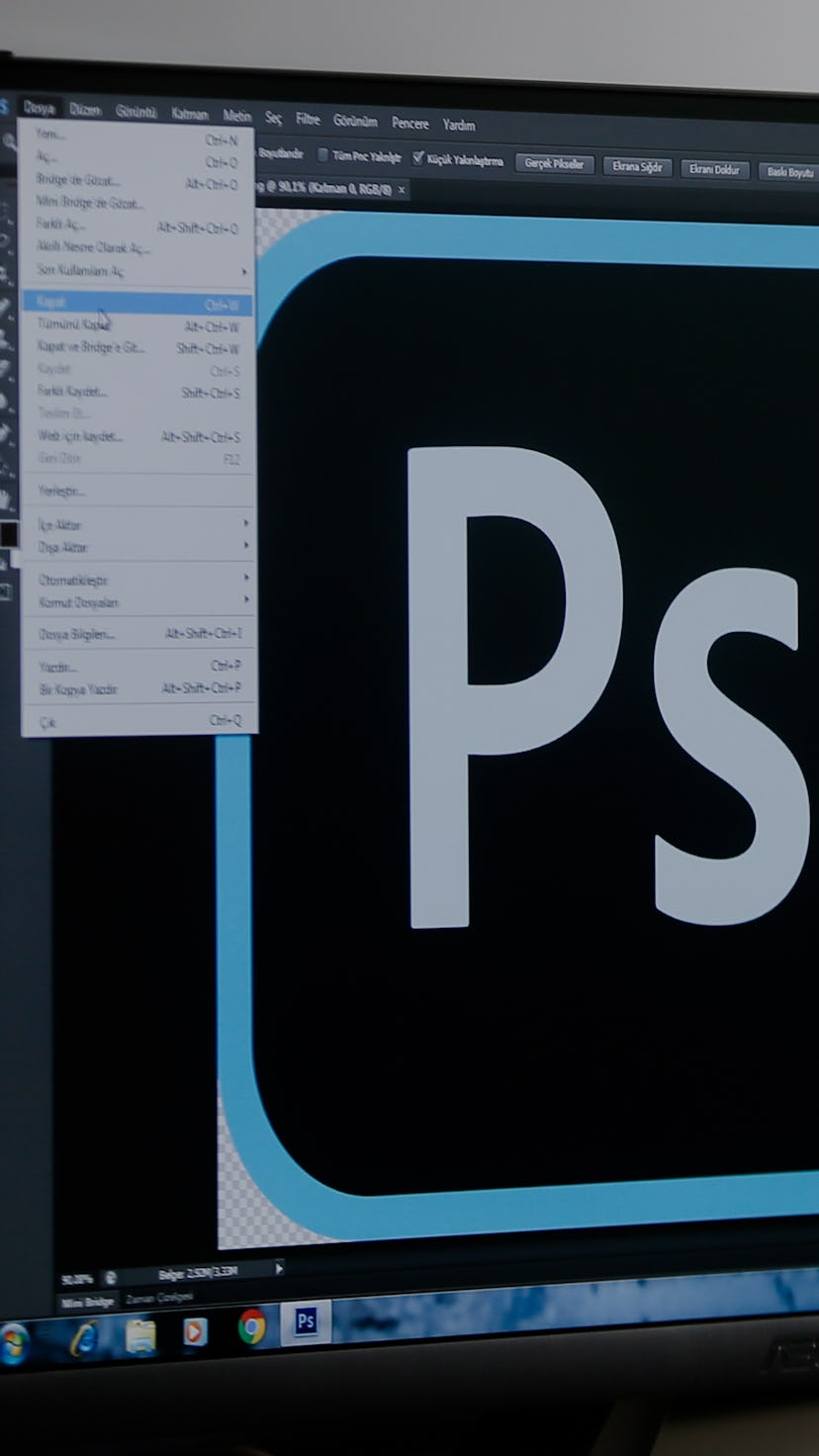 A person sitting at a computer using Photoshop.