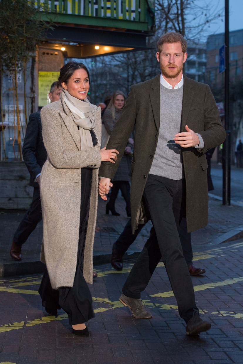 Meghan Markle holds Prince Harry's hand in 2018.