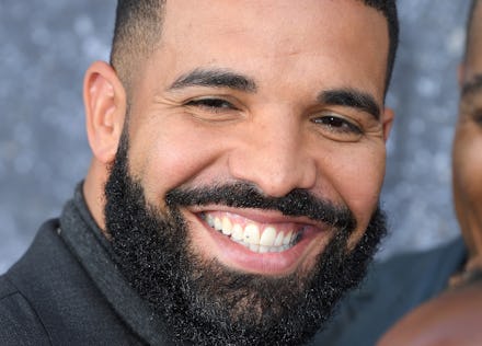 Drake smiling in a black shirt