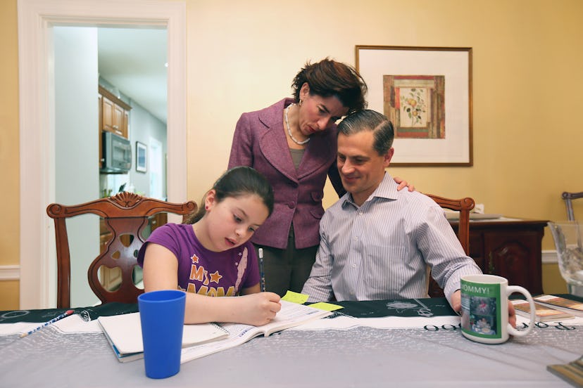 Gina Raimondo and her husband, Andrew Moffit, help their daughter Cecilia Moffitt with her homework.