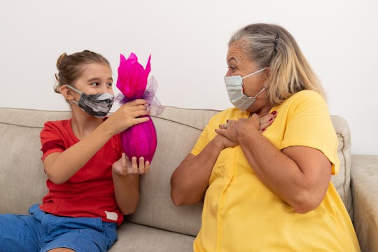 grandaughter giving grandmother a gift