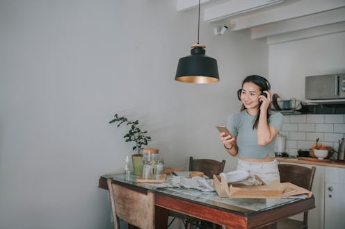 A woman listens to a Clubhouse chat. Here's how to find your friends on clubohuse.