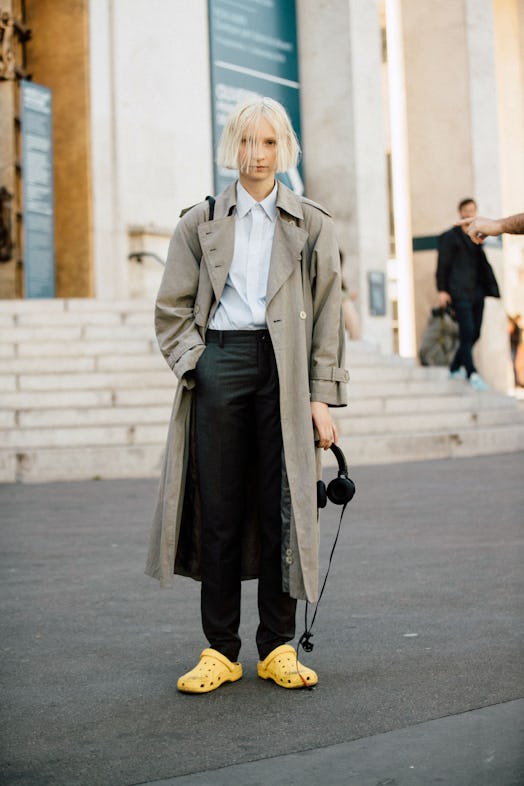 PARIS, FRANCE - SEPTEMBER 26: Model/Artist Ana Viktoria wears a trenchcoat, carries headphones, and ...