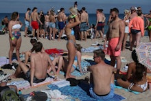 FORT LAUDERDALE, FLORIDA - MARCH 04: People walk on the beach on March 04, 2021 in Fort Lauderdale, ...