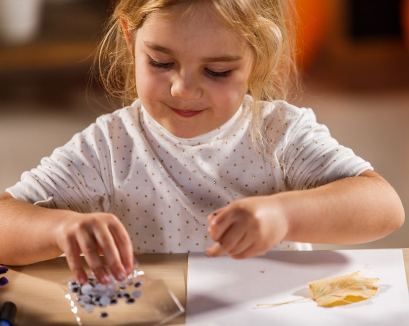 A girl getting crafty with googly eyes