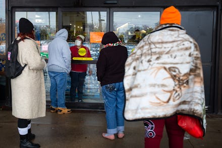 AUSTIN, TX - FEBRUARY 17, 2021: A Fiesta Mart staff member tells customers that the store is closed ...