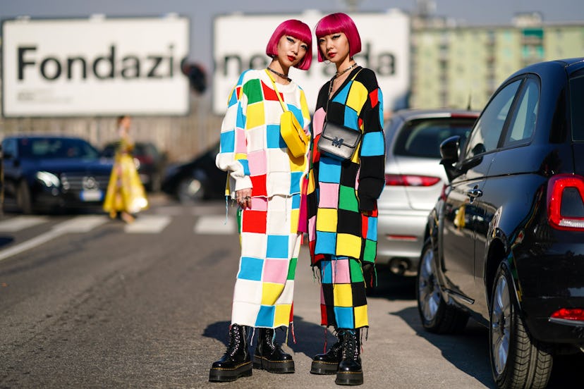 MILAN, ITALY - FEBRUARY 22: Fashion twins Ami Zuzuki and Aya Suzuki "AmiAya" wear earrings, a neckla...