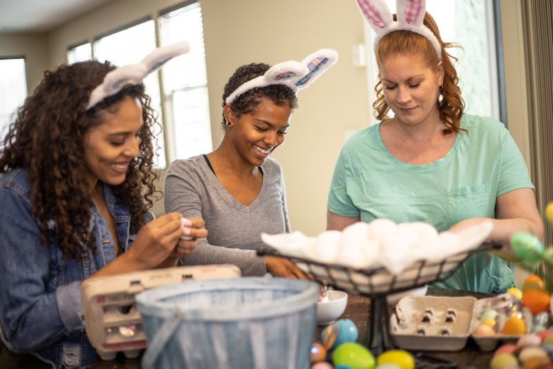 Adults celebrating Easter and dying eggs.
