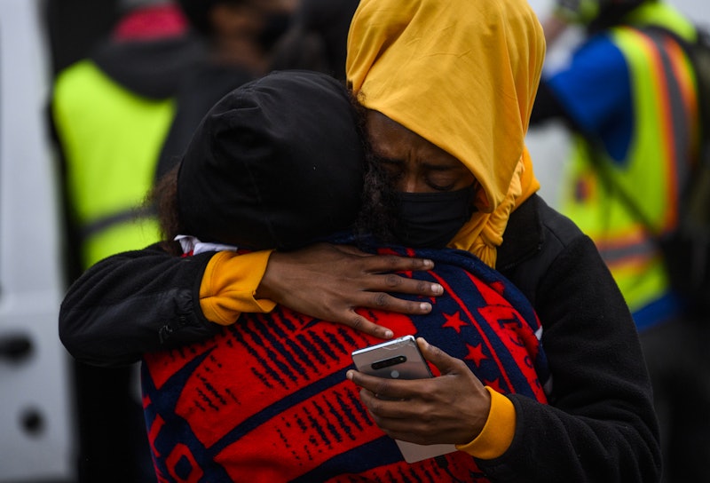 Two demonstrators embrace after 20 year old Daunte Wright was shot and killed during a traffic stop....