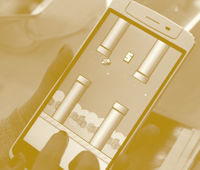 An employee plays the game Flappy Bird at a smartphone store in Hanoi on February 10, 2014. The Vie...