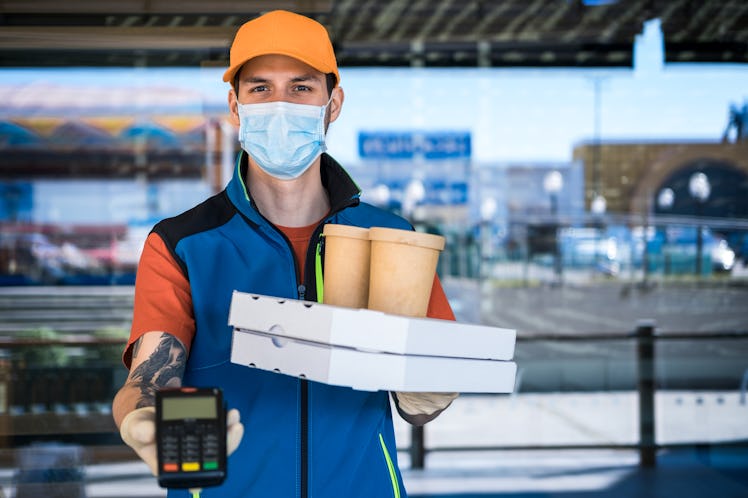 Man wearing mask delivering food