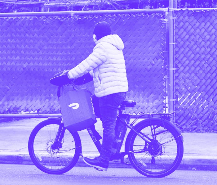 NEW YORK, NEW YORK - DECEMBER 04: A Doordash delivery person rides their bike on Church Avenue in th...
