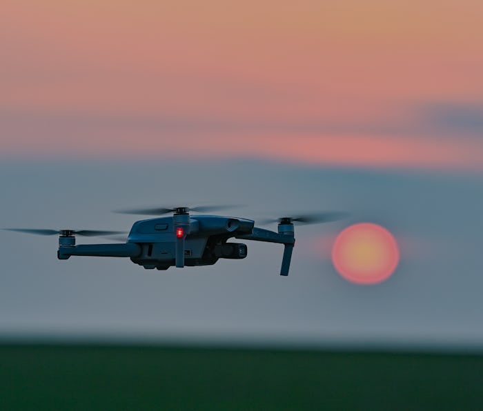 26 March 2021, Brandenburg, Sieversdorf: A DJI Mavic Air 2 quadrocopter (drone) flies over a field a...