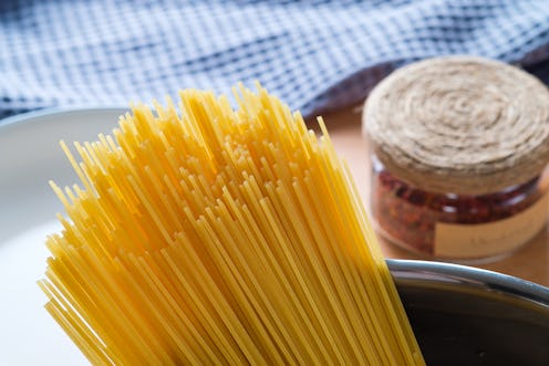 Raw Spaghetti or pasta in a saucepan for cooking and boiling food. Vegetarian and Vegan Food. Home l...