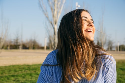 girl smiling and sitting outside