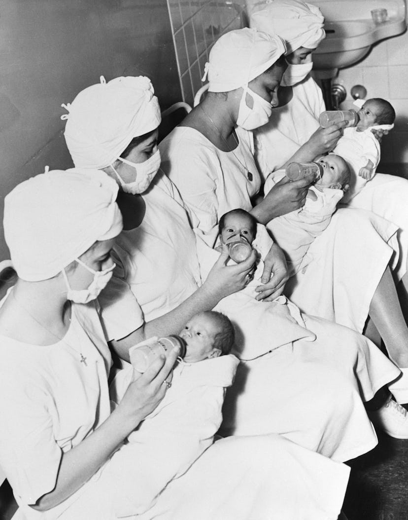 Nurses at the Bronx-Lebanon Hospital feed the Collins quadruplets. Nurses L-R: Lucille L. Wilers, Fl...