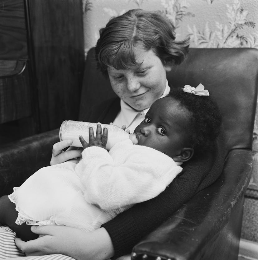 The mixed race Long family of Olyffe Avenue in Welling, Kent, July 1960. Twelve-year-old Joan helps ...