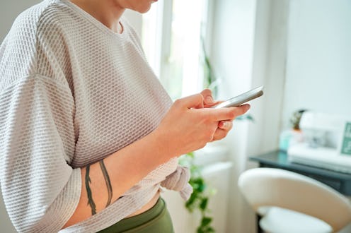 Woman looking at Instagram Stories anonymously.