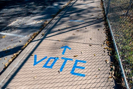 A sidewalk is shown with "Vote" written in tape outside a polling location on election dayy in Austi...