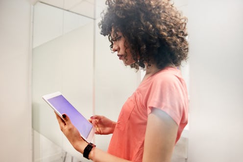 Woman looks at phone to increase interaction on Instagram Stories.