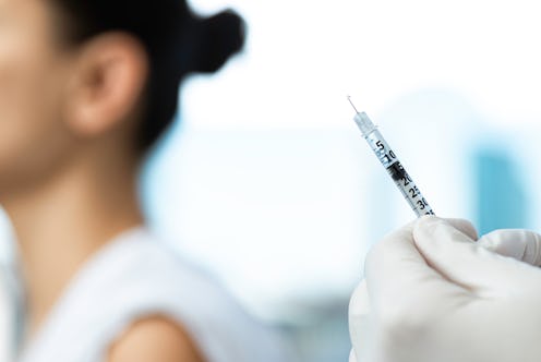 A woman is about to get a COVID vaccination. Right now it's not known how long COVID vaccine immunit...