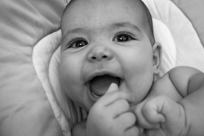 black and white photo of baby smiling