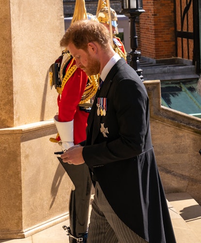 Britain's Prince Harry, Duke of Sussex, follows the coffin into St George's Chapel for the funeral s...