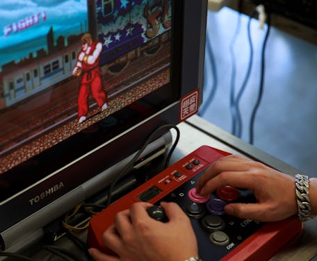 In this photo taken on August 12, 2017, a visitor plays the original 1980s Capcom classic Street Fig...