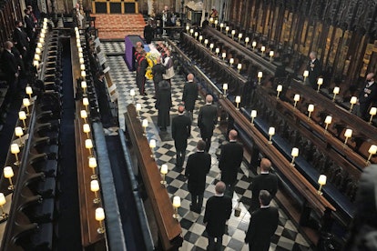 Members of the royal family stand behind the coffin as it arrives for the funeral service of Britain...