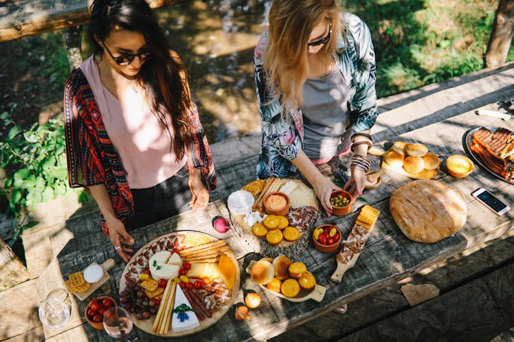 Women preparing a Mother's Day charcuterie board on TikTok.