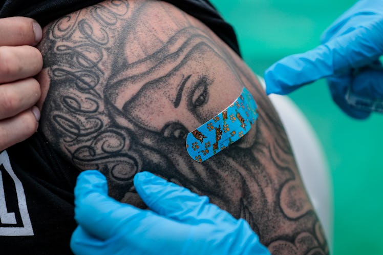 Los Angeles, CA, Wednesday, April 7, 2021 -
Homeboy employee Hector Rodriguez recieves a shot from...