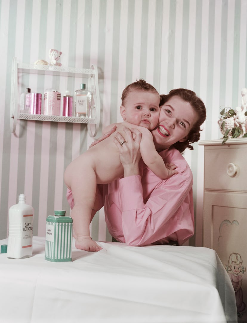 A 1950s photo of a mother and baby on the changing table.