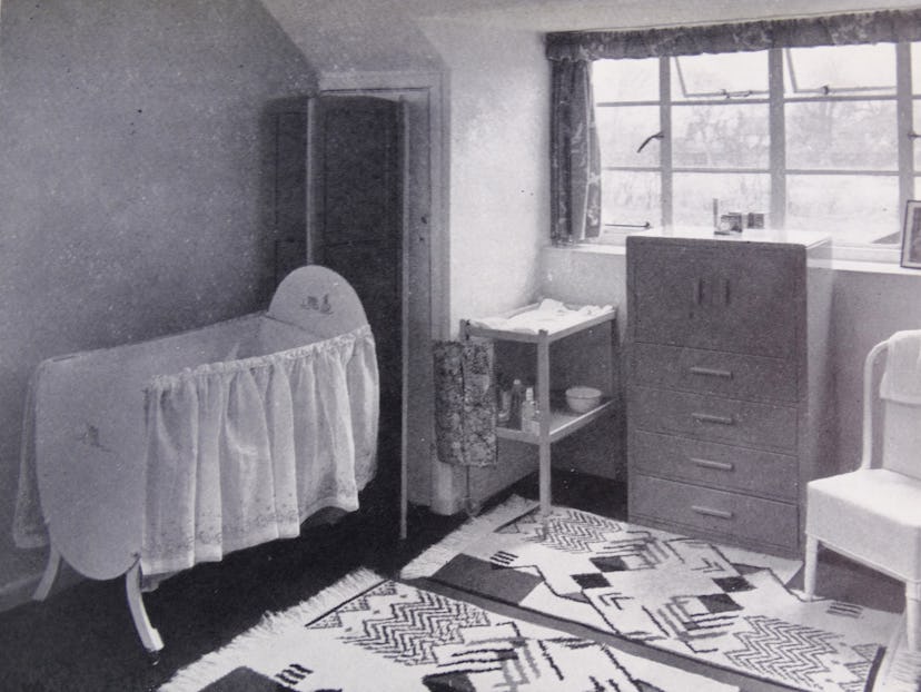 A small nursery with rugs.
