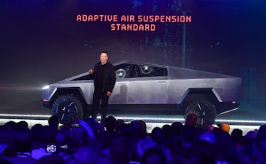 Tesla co-founder and CEO Elon Musk stands in front of the newly unveiled all-electric battery-powere...