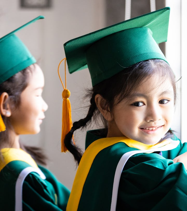 Asian child wearing graduation caps and gown needs a cute preschool graduation instagram caption