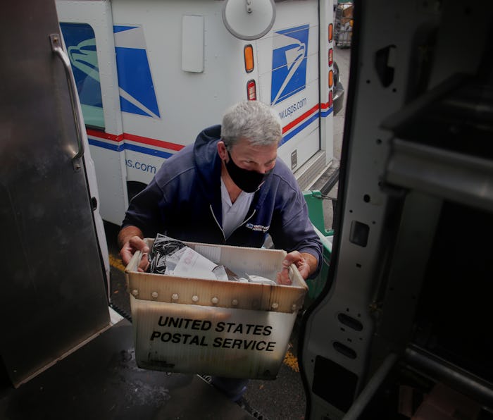 BOSTON, MA - DECEMBER 1: Letter carrier Steve Guerra loads his truck with the day's deliverables at ...
