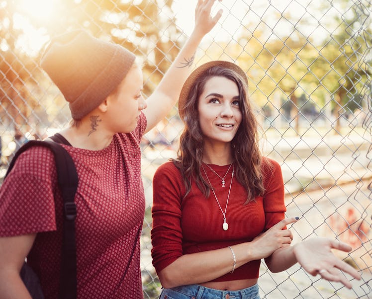 A couple leans against a fence. One person can tell their partner is lying.