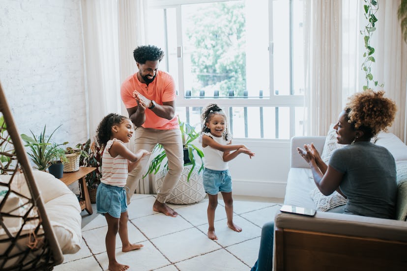 Happy family dancing at home on mother's day