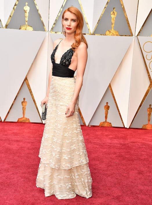 Emma Roberts arrives at the 89th Annual Academy Awards wearing a dress by Giorgio Armani and RCGD. 