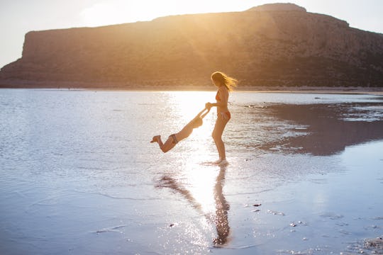 On the beach with a loved one during a family summer vacation.